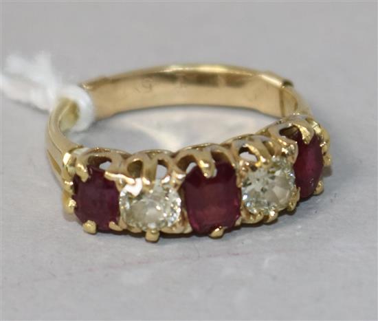 A gold and graduated five stone ruby and diamond set half hoop ring, size K.